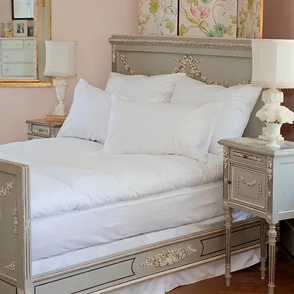 St. Genève Allergy Mattress Encasement on a French-style bed with ornate silver headboard and white pillows