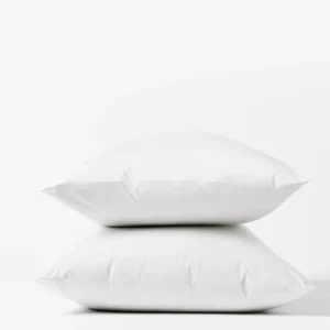 Coyuchi Heritage Percale pillowcase pair in white, two pillows stacked on white background.