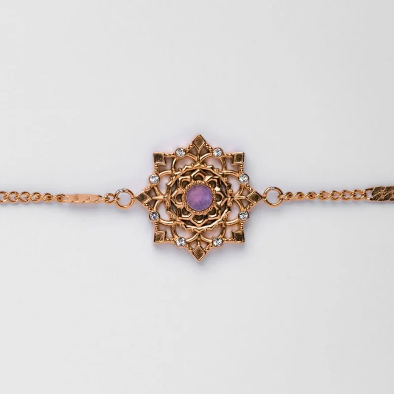Armband mit goldfarbenem Kettenglied und Schneeflocken-Anhänger mit violettem Stein