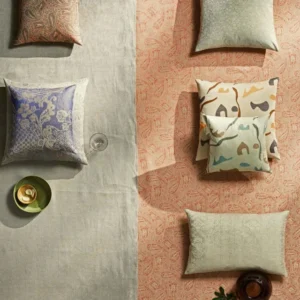 Leitner Esfahan firm decorative pillows in mixed patterns on linen and terracotta surfaces.