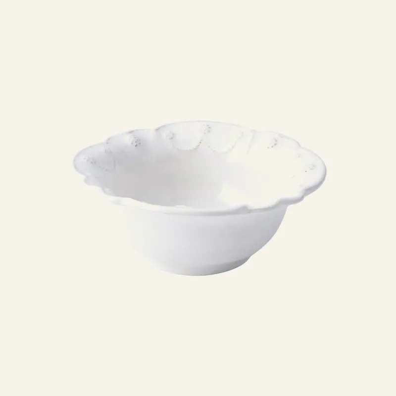 Juliska Jardins du Monde white stoneware cereal bowl with scalloped floral rim detail.