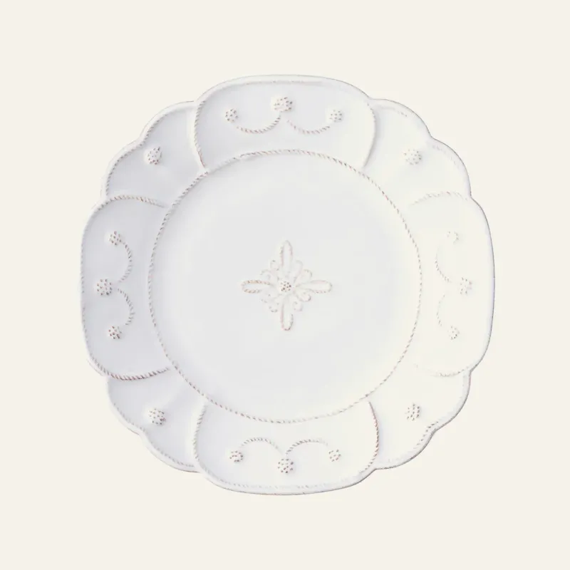 Juliska Jardins du Monde white ceramic salad plate with scalloped edge and floral motif.