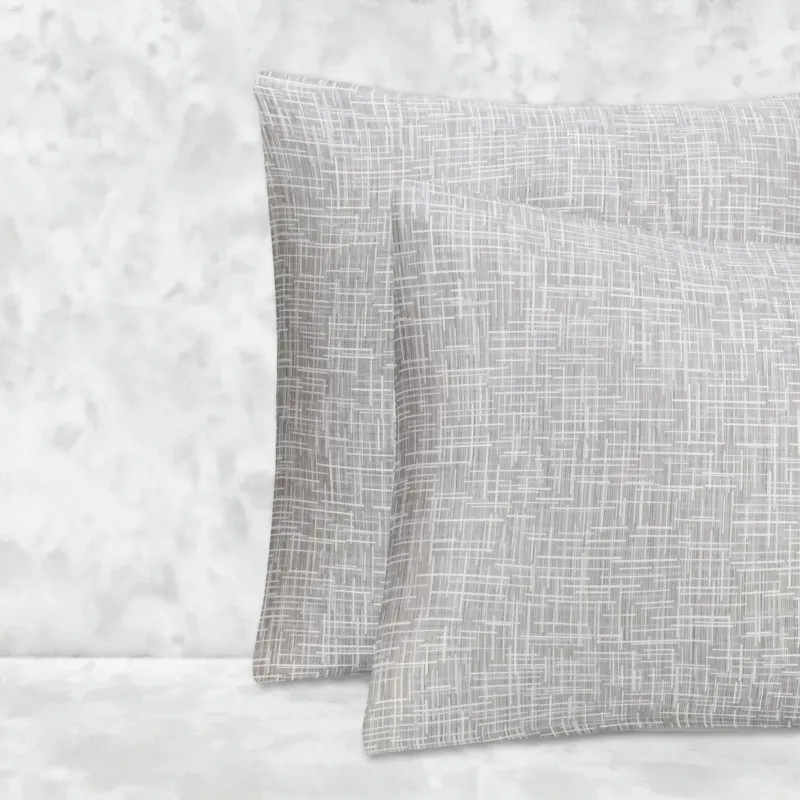 Two pillows stacked one in front of the other. The pillow cases are made of LETTO Mosaico Jacquard fabric in color Heather.