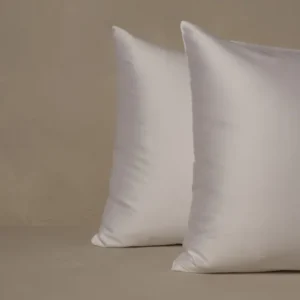 LETTO Sea Island Sateen white pillowcase set, pair of plump pillows on neutral linen surface.