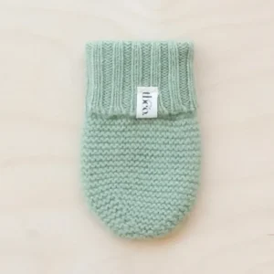 TBCo Merino Wool Baby Mittens in soft pistachio green, knitted with ribbed cuff detail and brand label