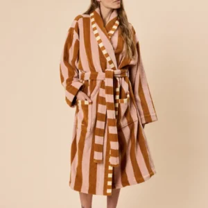 Model wearing TBCo Terry Cotton Bath Robe in Honeycomb Stripe with warm tones and striped belt tied at waist