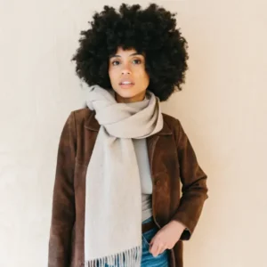 TBCo Lambswool Oversized Scarf in Oatmeal Melange styled casually with brown jacket and denim, showing fringed detail