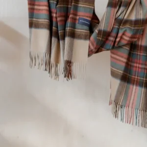 TBCo Stewart Dress Antique Tartan Lambswool Blanket Scarf draped elegantly showing plaid pattern and fringed edges in camel and red