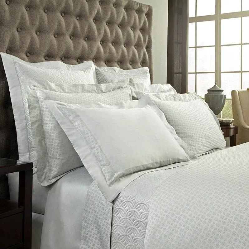Home Treasures Duomo quilted coverlet and euro sham set in ivory with geometric pattern.