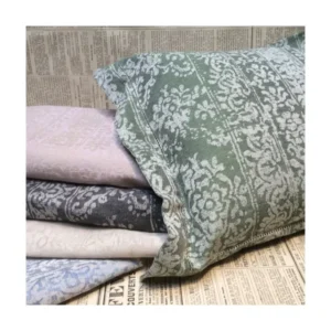 Leitner Teresa damask-patterned pillowcases and sheets in sage, lavender, and grey.